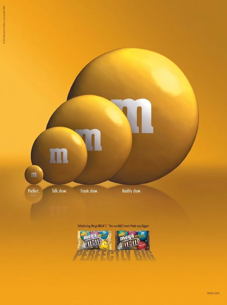 Mega M&M's print ad: four yellow M&M's grow in size, labeled Perfect, Talk show, Freak show and Reality show, above Mega M&M's packs and the tagline Perfectly Big