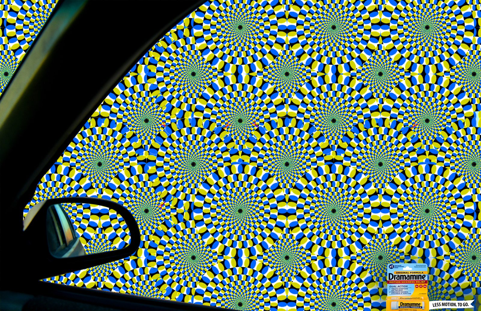 Dramamine print ad: whirling optical-illusion wheels fill the view from a car window and side mirror, with a Dramamine pack in the corner