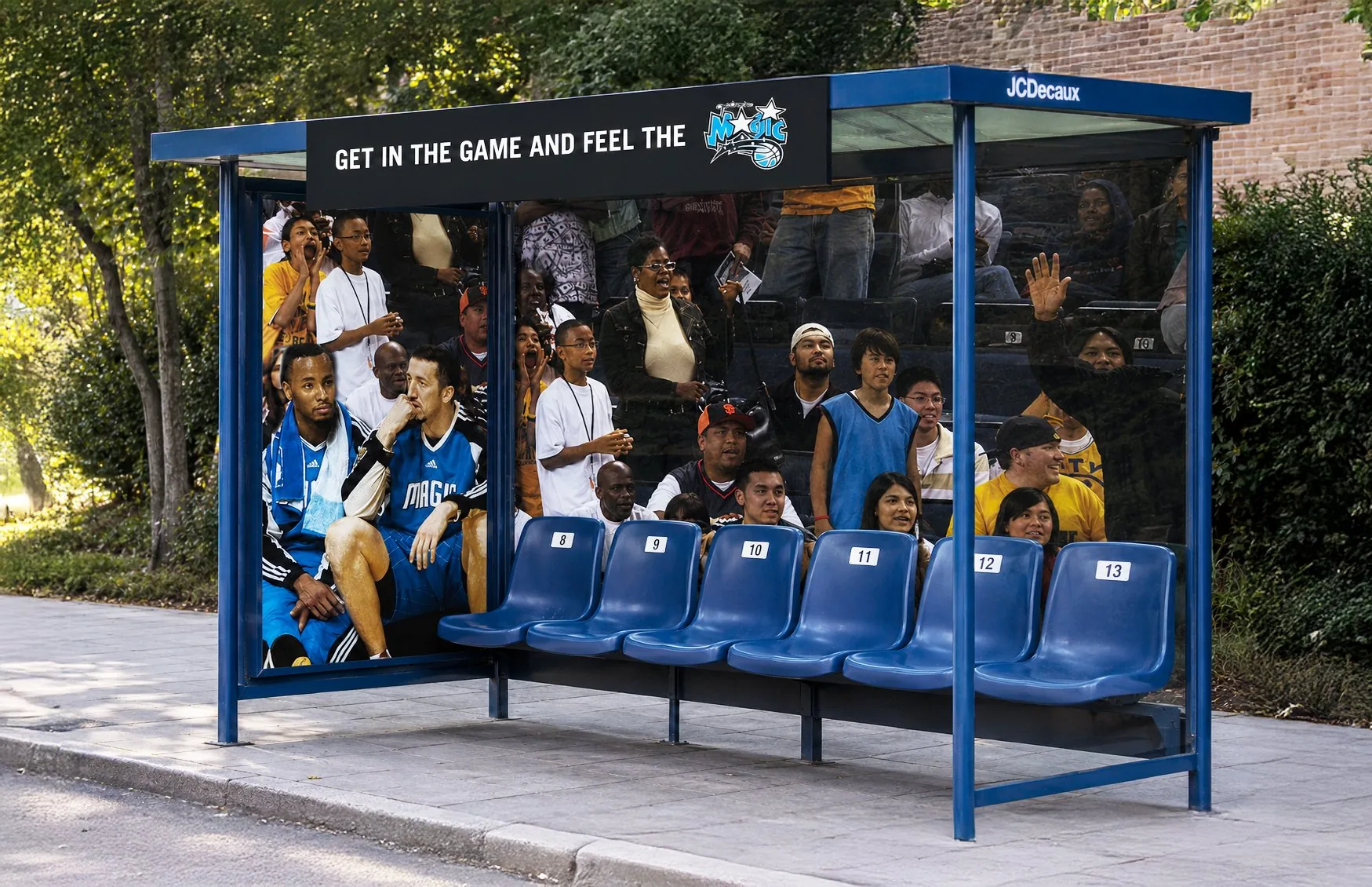 Orlando Magic bus-shelter takeover: numbered arena seats and a courtside crowd graphic under the headline Get in the game and feel the Magic