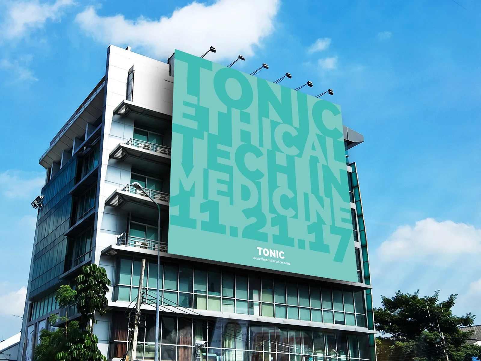 Large TONIC billboard mounted on a building face reading Tonic ethical tech in medicine 11.21.17 in tone-on-tone teal type