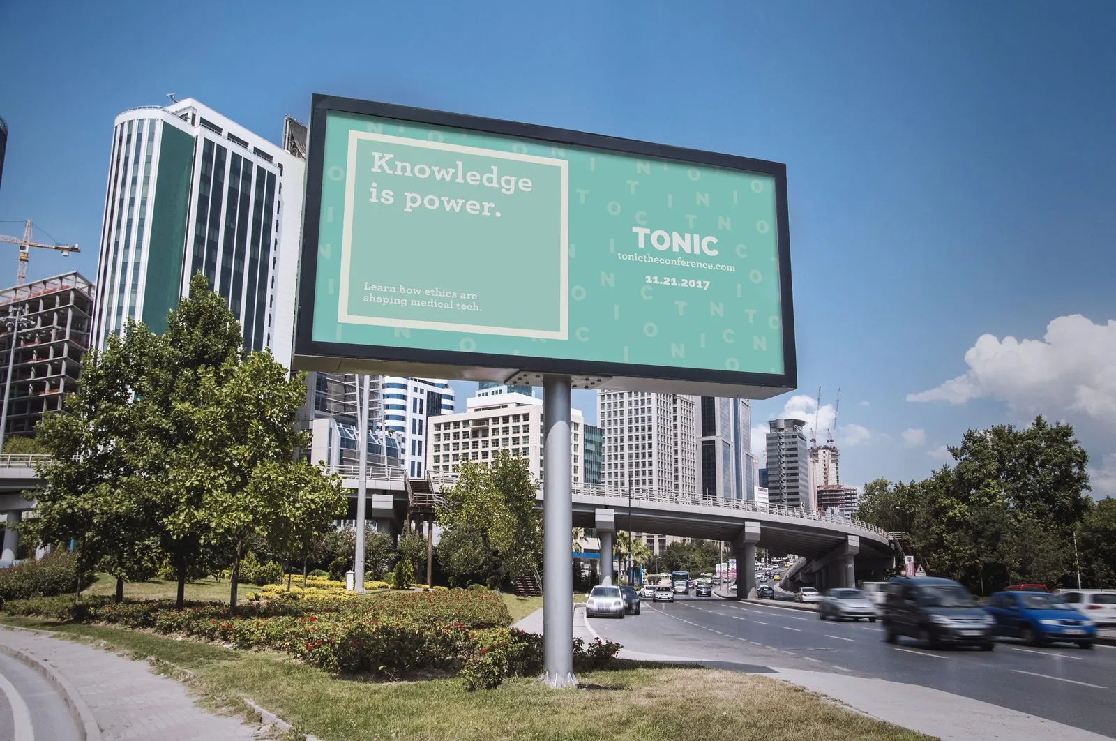 Roadside TONIC billboard over city traffic reading Knowledge is power, with the TONIC mark, tonictheconference.com and the 11.21.2017 date