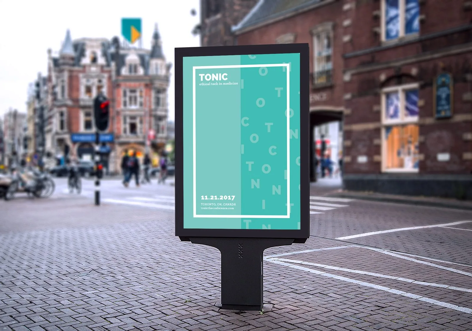TONIC street kiosk poster on a brick-paved corner listing 11.21.2017, Toronto, ON, Canada and tonictheconference.com