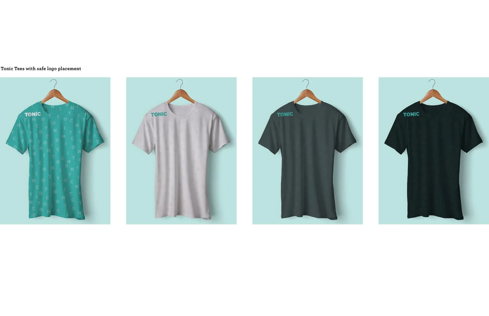 Four TONIC tees on wooden hangers in teal, white, charcoal and black, each with a small shoulder logo over the tonal letter pattern